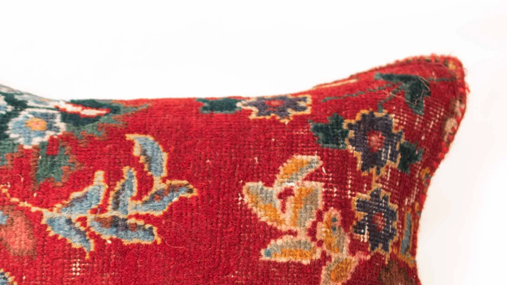 Close-up of an authentic handwoven vintage Persian rug cushion showing natural wool texture and traditional craftsmanship
