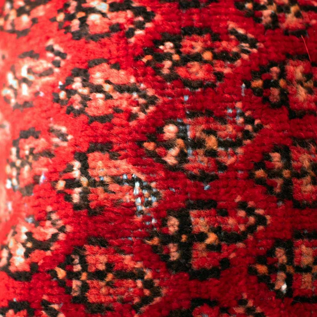 Close-up of an authentic handwoven Persian rug cushion highlighting its rich woven texture, intricate traditional pattern, and handcrafted wool fibers.